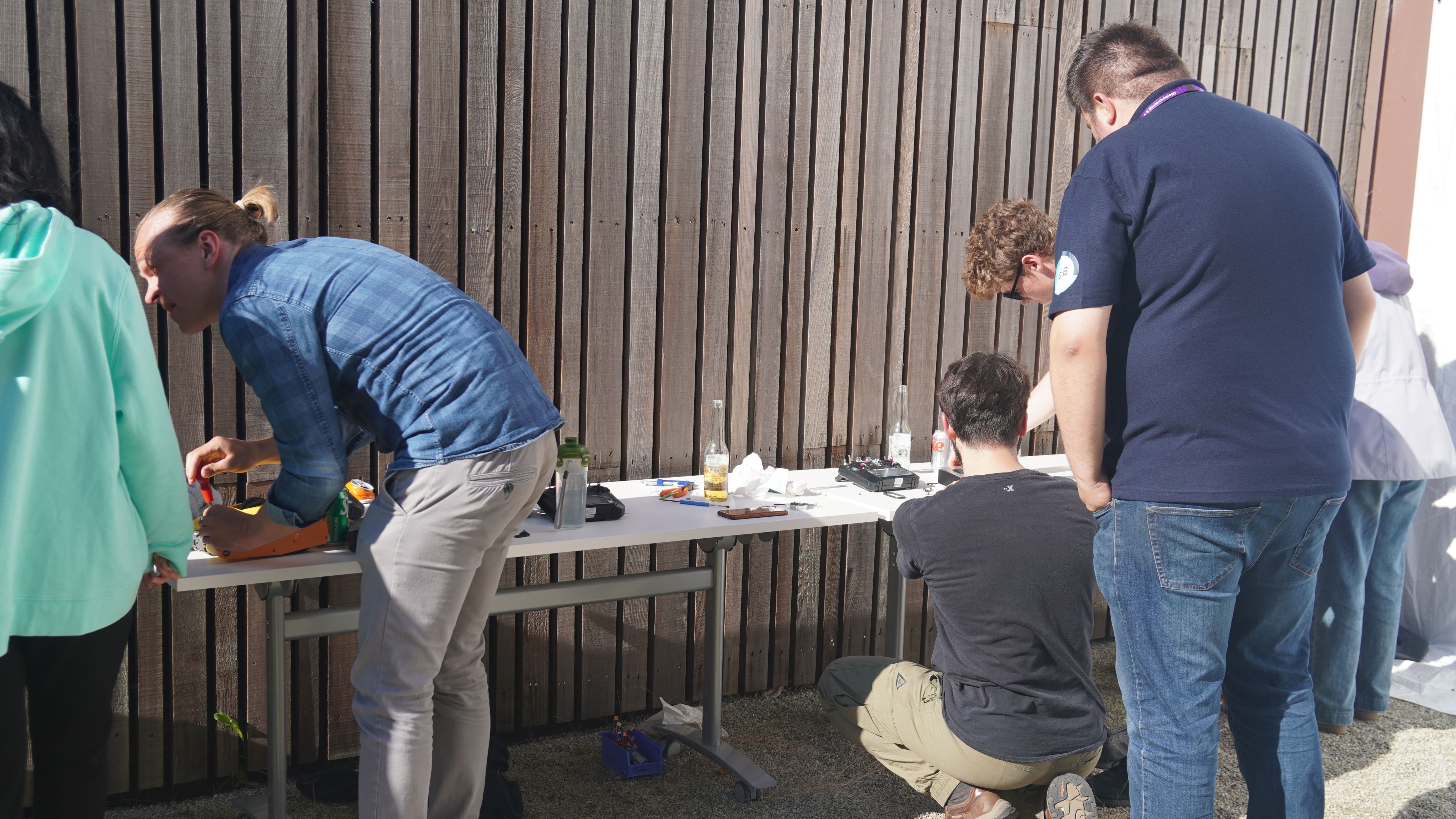 Teams work on one table on their robots