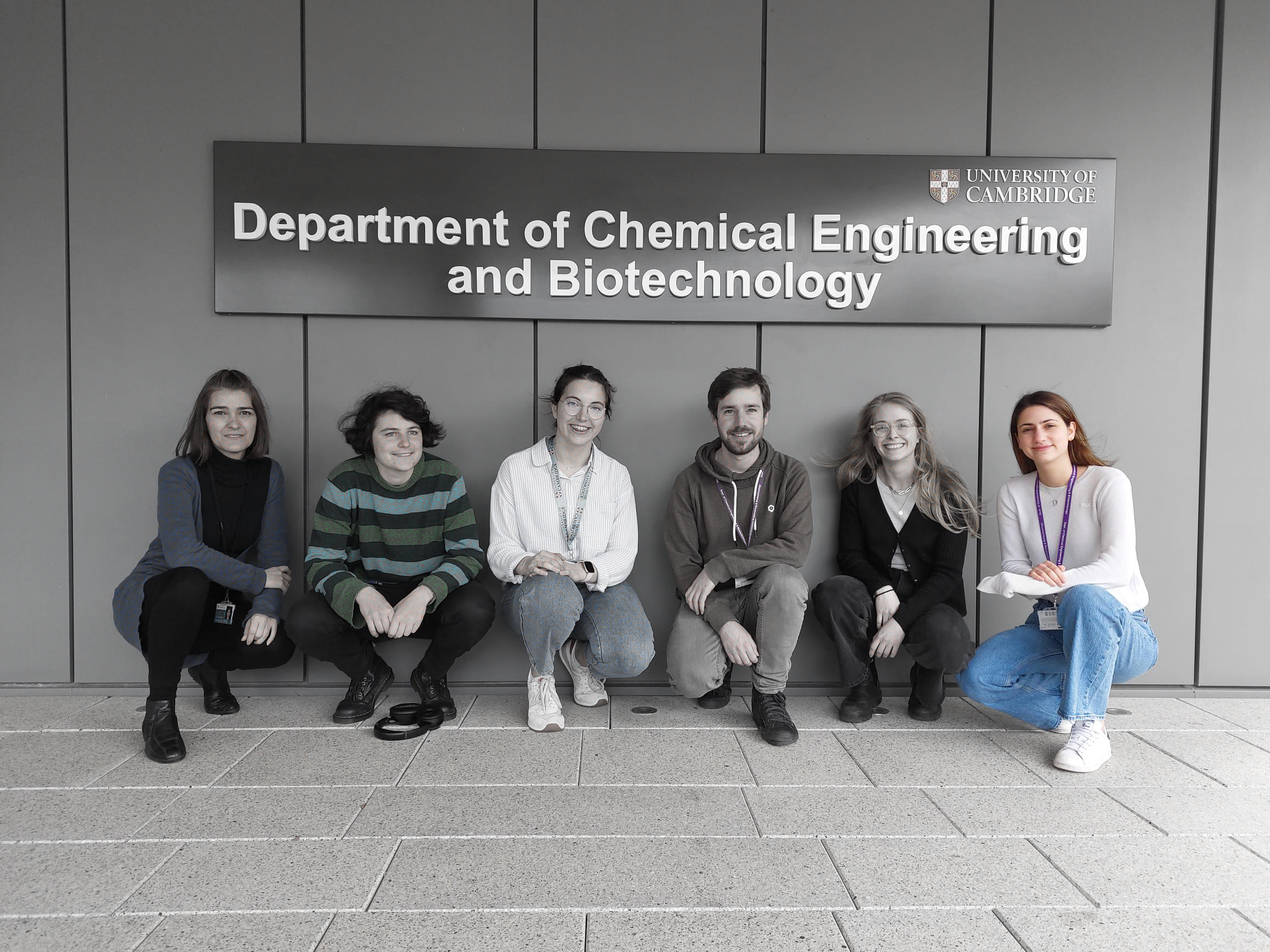 Six people crouched down in casual clothing under the department name outside. Photo lightly greyed except for Sofia on the far right.