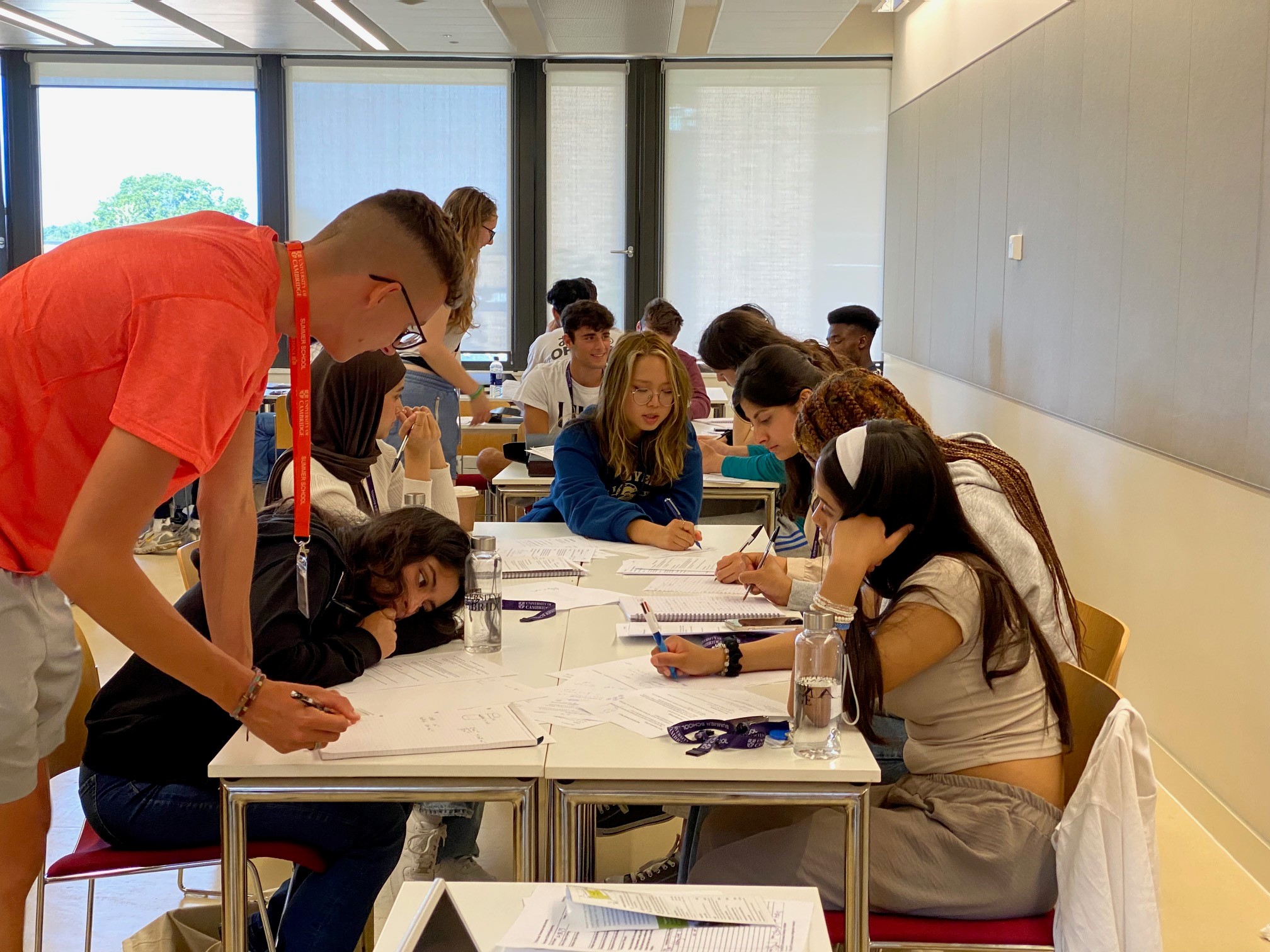 Year 12 students around a table working and smiling