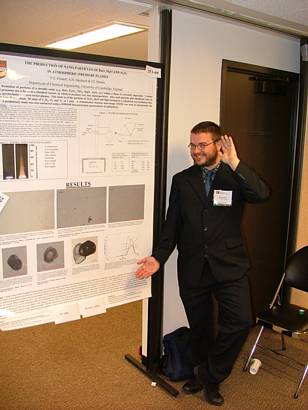 Paul Fennell posing with his poster, The production of nano-particles of MgO and Al2O3 in atmospheric-pressure flames at the 30th International Symposium on Combustion, the University of Illinois, Chicago on July 25th-30th 2004.
