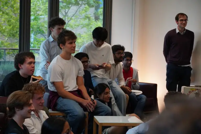 Group of students looking relaxed in some kind of presentation setting.